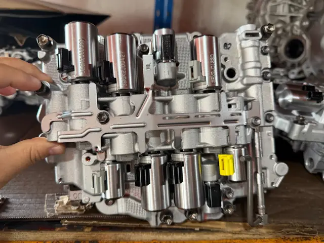 Valve body being checked by a technician