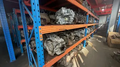 Rows of transmission assemblies on warehouse racks